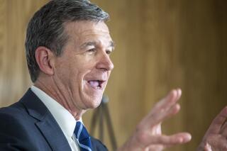 FILE - In this May 27, 2021 file photo, North Carolina Gov. Roy Cooper speaks to the gathered media after his tour of a COVID-19 vaccine clinic at the Pine Hall Brick plant in Madison, N.C. North Carolina's Senate approved a measure on Thursday, June 10, to prohibit doctors from performing abortions if a woman is seeking it because of race, sex or a prenatal diagnosis of Down syndrome. (Woody Marshall/News & Record via AP, File)