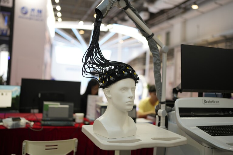 A device for scanning the human brain to help diagnose mental afflictions is displayed at the annual World Robot Conference at the Beijing Etrong International Exhibition and Convention Center in Beijing, Wednesday, Aug. 16, 2023. (AP Photo/Ng Han Guan)