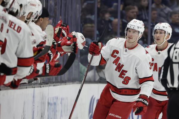 Carolina Hurricanes right wing Andrei Svechnikov (37) is congratulated by the bench after scoring against the Seattle Kraken during the second period of an NHL hockey game, Monday, Oct. 17, 2022, in Seattle. (AP Photo/John Froschauer)