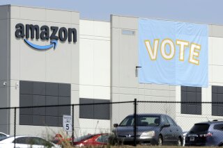 FILE - In this Tuesday, March 30, 2021 file photo, a banner encouraging workers to vote in labor balloting is shown at an Amazon warehouse in Bessemer, Ala. Amazon workers voted against forming a union, Friday, April 9, in Alabama, handing the online retail giant a decisive victory and cutting off a path that labor activists had hoped would lead to similar efforts throughout the company and beyond. (AP Photo/Jay Reeves, File)