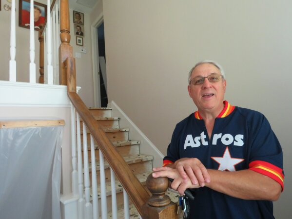 
              In this Oct. 25, 2017 photo, Paul Daulong talks about how the Astros' trip to the World Series has helped him and his family focus on something positive as they continue rebuilding their Houston home after it was flooded during Hurricane Harvey. Daulong says he believes he and others who are recovering after Harvey will follow the example of the Astros, who went through their own recent rebuilding process after several losing seasons, and "be back on top too." (AP Photo/Juan Lozano)
            