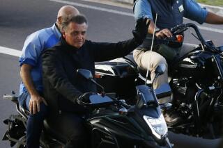 Brazil's President and presidential candidate Jair Bolsonaro leads a motorcycle rally, in Manaus, Brazil, Saturday, June 18, 2022. He will be running against his political nemesis, leftist former President Luiz Inacio Lula da Silva. While Bolsonaro has fervent support among his base, early polls say da Silva is leading handily before October's election. (AP Photo/Edmar Barros)