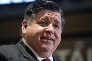 FILE - In this May 13, 2022 file photo, Illinois Gov. J.B. Pritzker speaks during a press conference at the Water Tower Place in the Gold Coast neighborhood, of Chicago. Inflation means stocking up on pencils, notebooks, crayons and folders for your kids’ return to school has a sharper financial edge this year, so state leaders on Thursday, Aug. 4, 2022 offered a 10-day sales tax reduction on classroom supplies. (Pat Nabong/Chicago Sun-Times via AP, File)