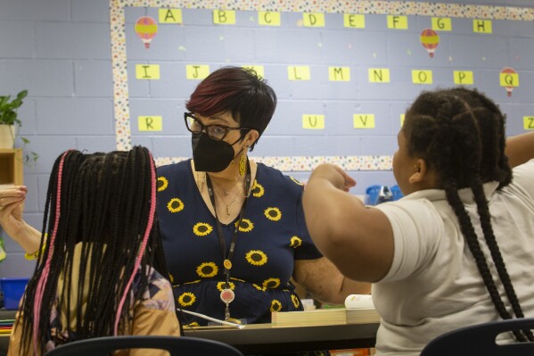 FILE - Third-grade students take part in a small group reading session at Beecher Hills Elementary School on Friday, Aug. 19, 2022, in Atlanta. Test scores released on Friday, July 28, 2023 show Georgia students made modest progress in the 2022-2023 school year, but remain below pre-pandemic achievement levels. (AP Photo/Ron Harris, File)