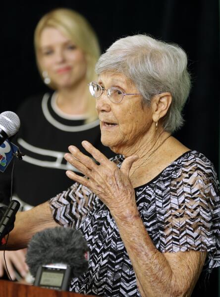 Ovell Krell, sister of George Owen Smith, the first victim positively identified from one of the 55 unmarked graves the former Arthur G. Dozier School for Boys in Marianna, Fla., speaks during a news conference Thursday, Aug. 7, 2014, at the University of South Florida in Tampa, Fla.  University researchers will exhume Smith's remains and return them to his family. Smith was 14 when he disappeared from the school in 1940, and was never seen alive by his family again. Looking on is Florida Attorney General Pam Bondi.  (AP Photo/Chris O'Meara)