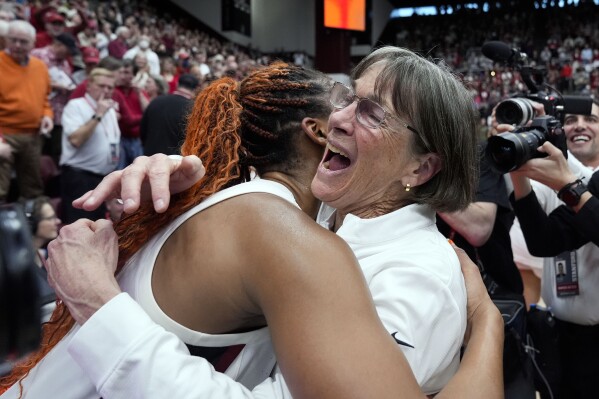 FILE - Stanford head coach Tara VanDerveer, right, is congratulated by forward Kiki Iriafen after breaking the college basketball record for wins, 1,203, following her team's win over Oregon State in an NCAA college basketball game, Sunday, Jan. 21, 2024, in Stanford, Calif. VanDerveer, the winningest basketball coach in NCAA history, announced her retirement Tuesday night, April 9, 2024, after 38 seasons leading the Stanford women’s team and 45 years overall. (AP Photo/Godofredo A. Vásquez, File)