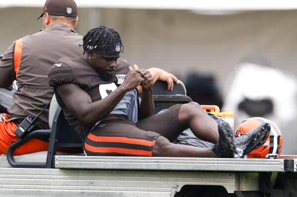 Cleveland Browns wide receiver Jakeem Grant Sr. is carted off the field after getting injured during a drill at the NFL football team's training camp, Tuesday, Aug. 9, 2022, in Berea, Ohio. (AP Photo/Ron Schwane)