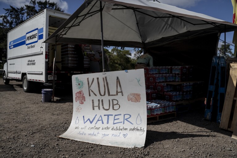 Water is available at a distribution hub by Kula Lodge on Wednesday, Sept. 27, 2023, in Kula, Hawaii. (AP Photo/Mengshin Lin)
