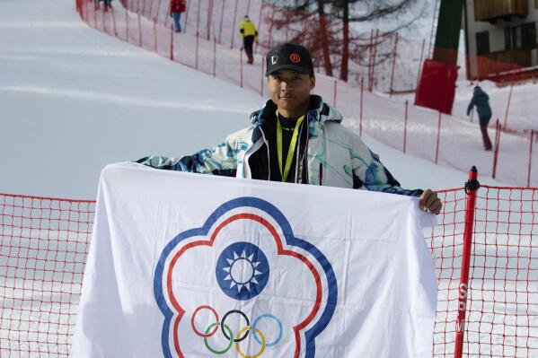 In this photo provided by Szollos Peter, Ray Ho is holds a flag in Italy on Feb. 26, 2019, created to represent Chinese Taipei, the name under which Taiwan competes under in international sporting competitions. Under an agreement struck by the Taiwan government and the IOC in 1981 they compete under the name and flag of Chinese Taipei after a referendum to change their name to Taiwan failed in 2018. (Szollos Peter via AP)