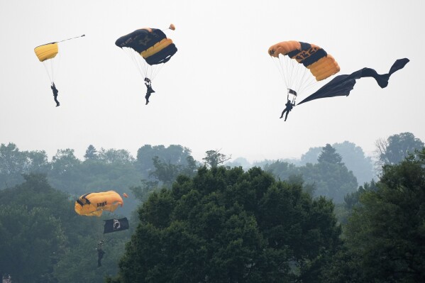 Members of the U.S. Army Parachute Team Golden Knights make their landing during an event to honor the Army's 250th anniversary, coinciding with President Donald Trump's 79th birthday, Saturday, June 14, 2025, in Washington. (AP Photo/Mark Schiefelbein)