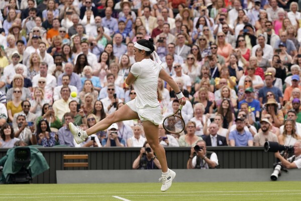Tunisia's Ons Jabeur kicks the ball after failing to chase down a volley by Aryna Sabalenka of Belarus in their women's singles semifinal match on day eleven of the Wimbledon tennis championships in London, Thursday, July 13, 2023. (AP Photo/Alberto Pezzali)