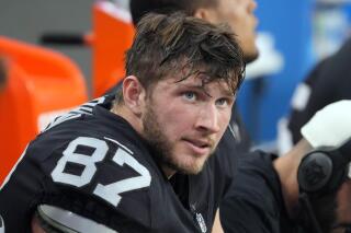 FILE - Las Vegas Raiders tight end Foster Moreau (87) watches from the sideline during the first half of an NFL football game against the Kansas City Chiefs, Saturday, Jan. 7, 2023, in Las Vegas. NFL tight end Foster Moreau has signed a three-year, $12 million contract with the Saints less than two months after being diagnosed with Hodgkin lymphoma during a physical with New Orleans, Moreau's agent said Wednesday, May 10, 2023. (AP Photo/Rick Scuteri, File)