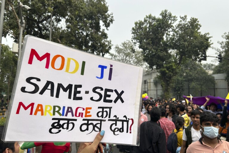 A placard written in Hindi and English saying 'Modi ji, when will you allow same-sex marriage?' Is carried by a participant of the Delhi Queer Pride Parade in New Delhi, India, Sunday, Nov. 26, 2023. This annual event comes as India's top court refused to legalize same-sex marriages in an October ruling that disappointed campaigners for LGBTQ+ rights in the world's most populous country. (AP Photo/Shonal Ganguly)