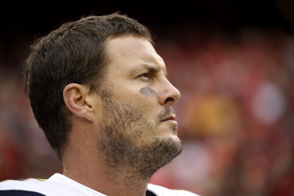 FILE - In this Dec. 29, 2019, file photo Los Angeles Chargers quarterback Philip Rivers stands for the national anthem before an NFL football game against the Kansas City Chiefs in Kansas City, Mo. Rivers' career with the Los Angeles Chargers has come to an end. The franchise announced Monday, Feb. 10, 2020, that Rivers will enter free agency and not return for the upcoming season. (AP Photo/Charlie Riedel, File)