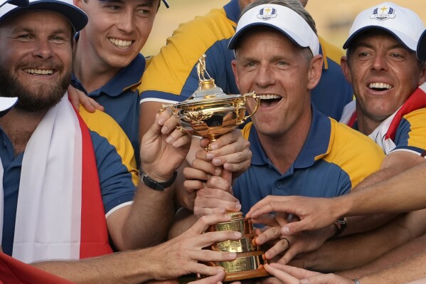 FILE - Europe's Team Captain Luke Donald, centre, and team members lift the Ryder Cup after winning the trophy by defeating the United States 16/12 point to 11 1/2 points at the Marco Simone Golf Club in Guidonia Montecelio, Italy, on Oct. 1, 2023. Luke Donald is staying on as captain of the European team for its defense of the Ryder Cup in 2025 at Bethpage Black. The 45-year-old Donald led the Europeans to a 16陆-11陆 victory over the United States outside Rome last month and the European tour said Wednesday Nov. 29, 2023 he is being retained as captain. (AP Photo/Alessandra Tarantino, File)