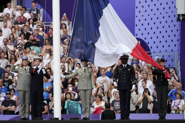 Military raise the French flag during the 2024 Summer Olympics closing ceremony at the Stade de France, Sunday, Aug. 11, 2024, in Saint-Denis, France. (AP Photo/Natacha Pisarenko)