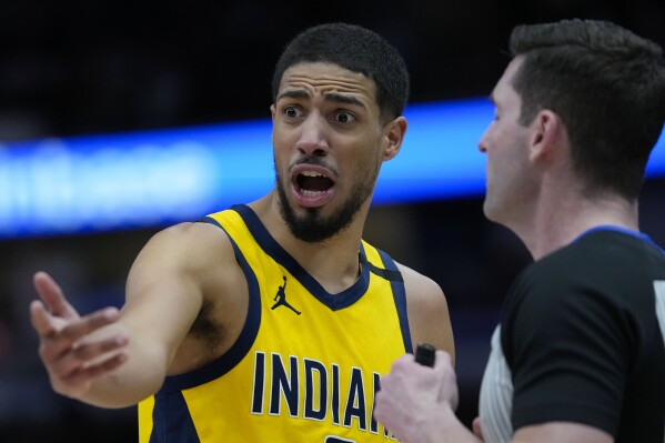 Indiana Pacers guard Tyrese Haliburton, left, argues a call with a referee, right, during the second half of an NBA basketball game against the Chicago Bulls, Thursday, Dec. 28, 2023, in Chicago. (AP Photo/Erin Hooley)