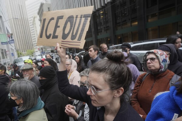 A person holds up a sign during a news conference and rally by immigrant justice organizations and advocates protesting ICE arrests in San Francisco, Wednesday, May 28, 2025. (AP Photo/Jeff Chiu, File)