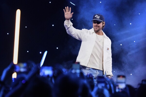 Actor Ryan Gosling waves at audience members during a fan convention called the Star Wars Celebration in Chiba, near Tokyo, Friday, April 18, 2025. (AP Photo/Hiro Komae)