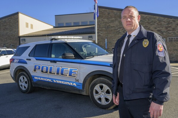 Marion Police Chief John Clair poses outside the Marion Police Department building, Monday, Feb. 5, 2024, in Marion, Va. Clair, chief of the small Appalachian town, spends his days consumed by a growing problem: the frequency with which his officers are tapped to detain, transport and wait in hospitals with people in the throes of a mental health crisis. (AP Photo/Earl Neikirk)