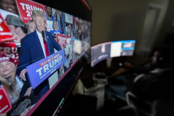 Monitors at Right Side Broadcasting Network in Opelika, Ala., display Republican presidential candidate former President Donald Trump speaking at a campaign rally in North Carolina on Saturday, March 2, 2024. In less than a decade, RSBN has gone from upstart internet broadcaster to major player in Trump's MAGA universe, amassing more than two million subscribers on its YouTube channel and on Rumble, an alternative video-sharing platform. (AP Photo/Mike Stewart)