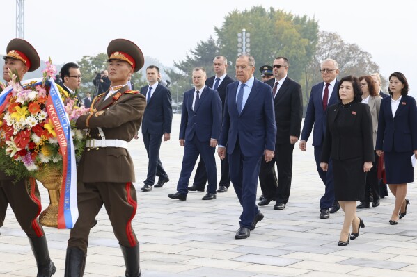 In this photo released by Russian Foreign Ministry Press Service via their telegram channel, Russian Foreign Minister Sergey Lavrov, foreground left, and North Korean Foreign Minister Choe Son Hui, foreground right, attend a wreath-laying ceremony at the base of the bronze statues of their late leaders Kim Il Sung and Kim Jong Il at Mansu Hill Grand Monument in Pyongyang, North Korea, on Thursday, Oct. 19, 2023. (Russian Foreign Ministry Press Service telegram channel via AP)