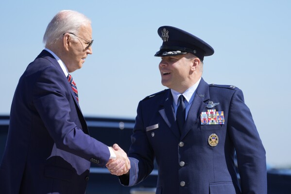 President Joe Biden is greeted by Col. Paul Pawluk, Vice Commander of the 89th Airlift Wing, as he arrives on Air Force One, Tuesday, May 21, 2024, at Andrews Air Force Base, Md. Biden is returning from New Hampshire and Boston. (AP Photo/Alex Brandon)