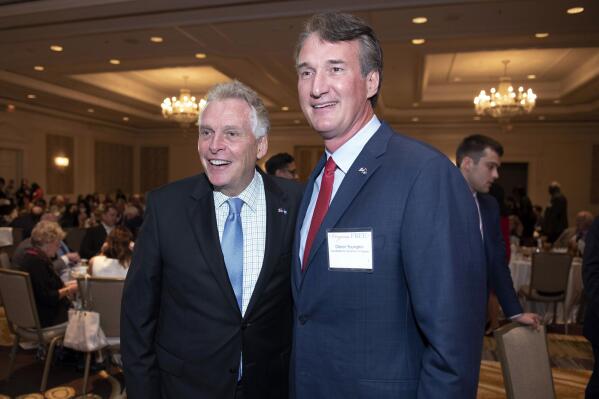 FILE - Virginia gubernatorial candidates, Democrat Terry McAuliffe left, and Republican Glenn Youngkin, pose for a photo, during the Virginia FREE leadership luncheon, in McLean, Va.  McAuliffe and Youngkin are set to square off in Virginia’s first gubernatorial debate of the general election season, Thursday, Sept. 16. The race is being closely watched as a possible indicator of voter sentiment heading into the 2022 national midterm elections.    (AP Photo/Cliff Owen, File)