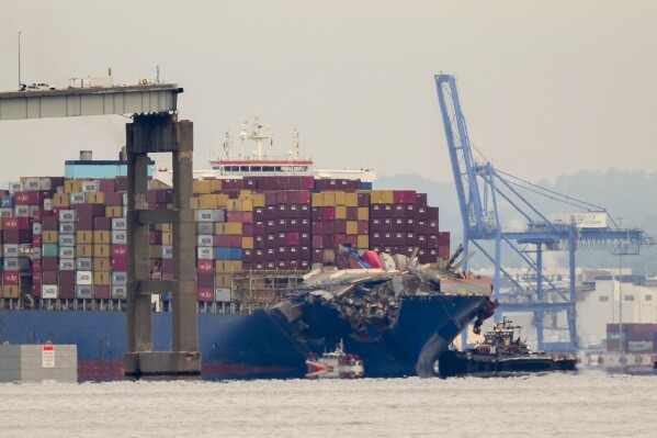 Tugboats escort the cargo ship Dali after it was refloated in Baltimore, Monday, May 20, 2024. The vessel struck the Francis Scott Key Bridge on March 26 causing it to collapse and resulting in the death of six people. (AP Photo/Matt Rourke)