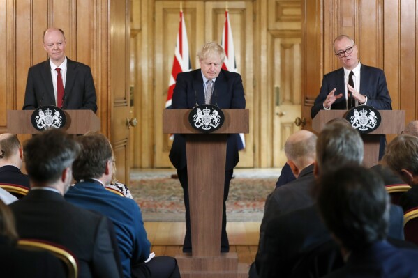 FILE - Britain's prime Minister Boris Johnson, centre, Chief Medical Officer for England Chris Whitty, left, and Chief Scientific Adviser Patrick Vallance speak hold a press conference at Downing Street on the government's coronavirus action plan in London, Tuesday, March 3, 2020. Johnson, the former British prime minister, struggled to come to grips with much of the science during the coronavirus pandemic, according to his then chief scientific advisor. In keenly awaited testimony Monday, Nov. 20, 2023 to the country’s public inquiry into the COVID-19 pandemic, Patrick Vallance said he and others faced repeated problems getting Johnson to understand the science. (AP Photo/Frank Augstein, Pool, File)