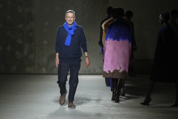 FILE - Belgian fashion designer Dries Van Noten accepts applause after his Fall/Winter 2024-2025 ready-to-wear collection presented Wednesday, Feb. 28, 2024 in Paris. Van Noten said Tuesday, March 19, 2024, he will step down from his namesake brand at the end of June. (Scott A Garfitt/Invision/AP, File)