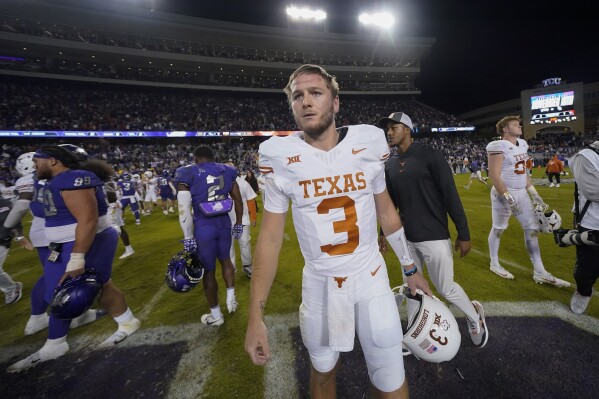 Texas quarterback Quinn Ewers walks on the field after an NCAA college football game against TCU, Saturday, Nov. 11, 2023, in Fort Worth, Texas. Texas won 29-26. (AP Photo/Julio Cortez)