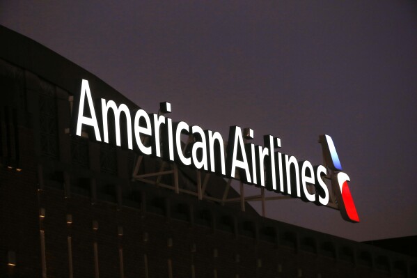 The American Airlines logo is shown on top of the American Airlines Center in Dallas, Texas on Dec. 19, 2017. (AP Photo/ Michael Ainsworth)