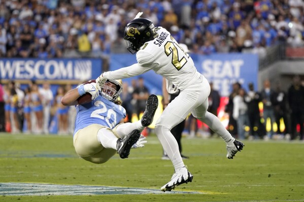 Colorado safety Shilo Sanders, right, puts a hit on UCLA running back Carsen Ryan during the first half of an NCAA college football game Saturday, Oct. 28, 2023, in Pasadena, Calif. (AP Photo/Mark J. Terrill)