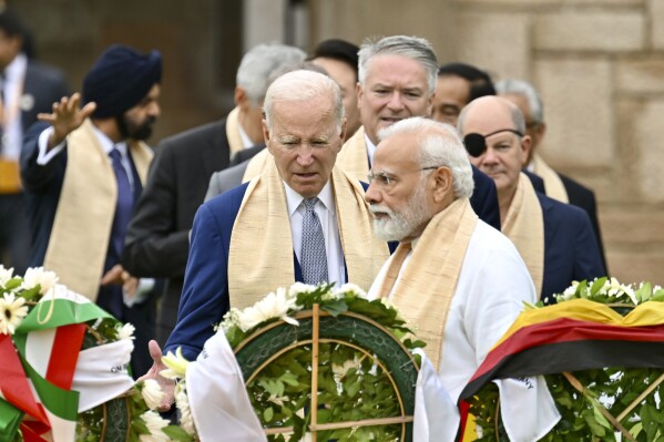 U.S. President Joe Biden, center, Indian Prime Minister Narendra Modi, and other G-20 leaders arrive to pay their tributes at the Rajghat, a Mahatma Gandhi memorial, in New Delhi, India, Sunday, Sept. 10, 2023. 