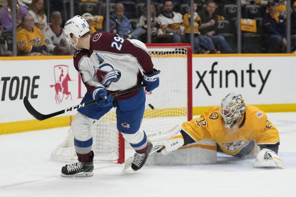 Colorado Avalanche center Nathan MacKinnon (29) looks back at the net as he scores a goal against Nashville Predators goaltender Kevin Lankinen (32) during the first period of an NHL hockey game Friday, April 14, 2023, in Nashville, Tenn. (AP Photo/Mark Humphrey)