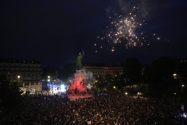 Fireworks depart off as of us stand in Republique Plaza and react to the projection of outcomes throughout the 2nd spherical of the legislative elections, in Paris, France, Sunday, July 7, 2024. Polls get closed in France, and polling projections teach a coalition on the left that came collectively impulsively has obtained maybe the most parliamentary seats in the pivotal runoff elections after a high turnout amongst voters. (AP Photo/Christophe Ena)