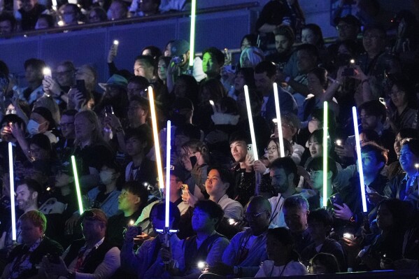 Fans watch opening act during the Star Wars Celebration in Chiba, near Tokyo, Friday, April 18, 2025. (AP Photo/Hiro Komae)