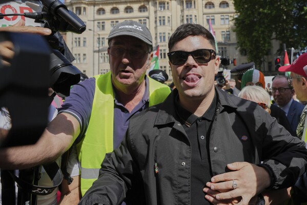 Naoise O Caireallain, a member of the Irish language band Kneecap, arrives at Westminster Magistrates Court in London, Wednesday, June 18, 2025, to support fellow band member Liam Óg Ó hAnnaidh, who is charged with a terrorism offence relating to displaying a flag in support of Hezbollah during a performance with the band in November 2024. (AP Photo/Kin Cheung)
