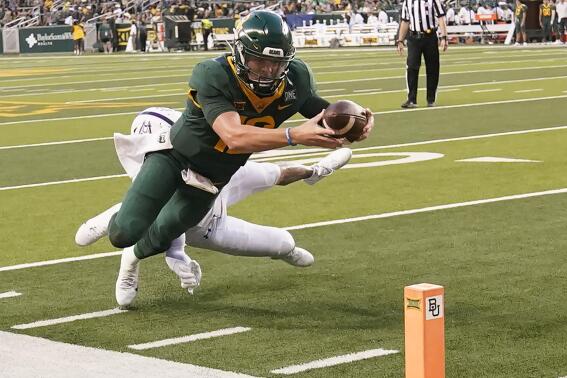 Baylor quarterback Blake Shapen (12) dives to score a touchdown against Albany defensive back Isaac Duffy (19) during the first half of an NCAA college football game in Waco, Texas, Saturday, Sept. 3, 2022. (AP Photo/LM Otero)
