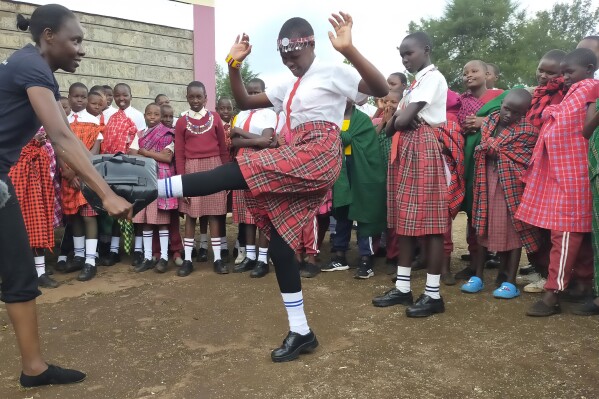 I'm Worth Defending officer Amelia Awuor, left, demonstrates self-defense techniques at Enkakenya Centre for Excellence in Narok County, Kenya, on Feb. 1, 2025. (AP Photo/Nicholas Komu)