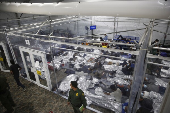 FILE - Children lie inside a pod at the main detention center for unaccompanied children in the Rio Grande Valley run by U.S. Customs and Border Protection (CBP), in Donna, Texas, March 30, 2021. A company that provides services for immigrants in federal detention was ordered Tuesday, April 2, 2024, to pay more than $811 million in restitution and penalties in a lawsuit alleging it used deceptive and abusive tactics. (AP Photo/Dario Lopez-Mills, Pool, File)