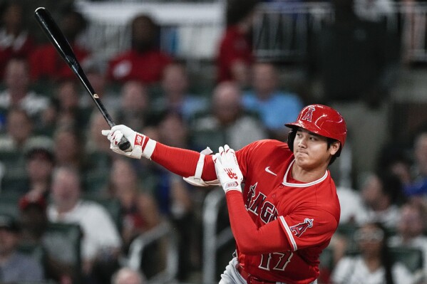 Los Angeles Angels' Shohei Ohtani hits a single in the seventh inning of a baseball game against the Atlanta Braves, Monday, July 31, 2023, in Atlanta. (AP Photo/John Bazemore)