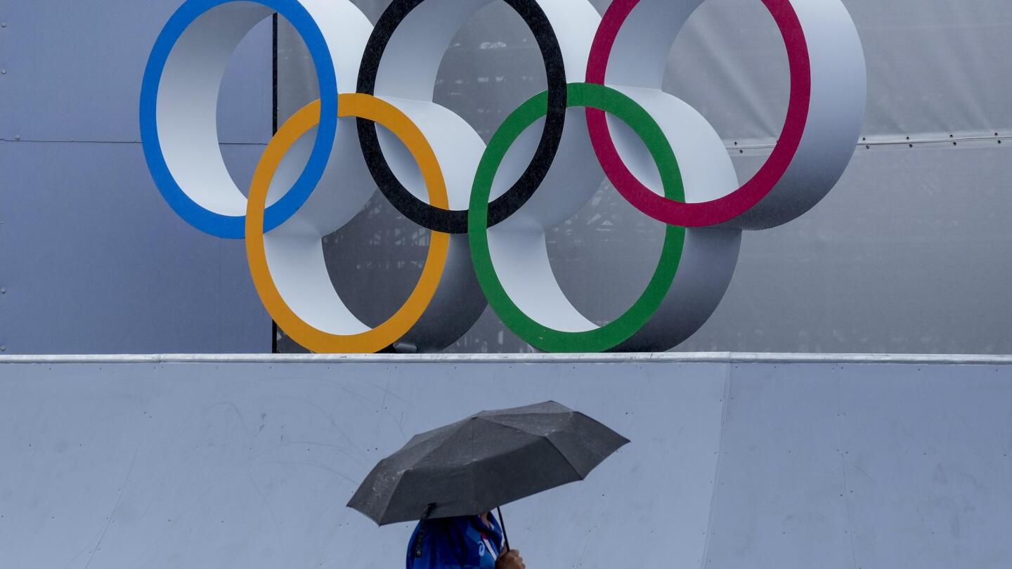 GLIMPSES As rain arrives and typhoon nears, Olympics endure AP News