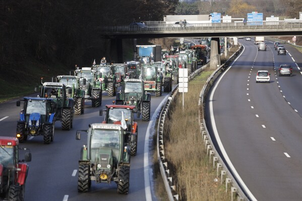 FILE - A farmer drives a tractor on a highway near Strasbourg on Wednesday, January 24, 2024. Eastern France.  (AP Photo/Jean-François Badias, File)