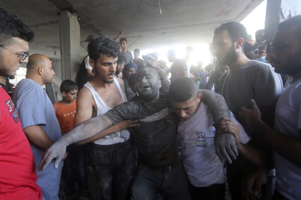 A Palestinian man reacts after being rescued from under the rubble of a destroyed building following an Israeli airstrike in Bureij refugee camp, Gaza Strip, Thursday, Nov. 2, 2023. (AP Photo/Mohammed Dahman)