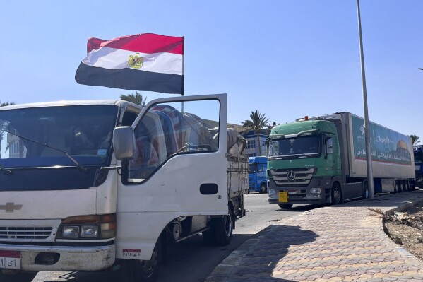 Humanitarian aid convoy for the Gaza Strip is parked in Arish, Egypt, Monday, Oct. 16, 2023. Hundreds of Palestinians in the Gaza Strip have fled their homes ahead of an expected Israeli ground invasion aimed at destroying Hamas after its fighters rampaged through southern Israel. (AP Photo/Omar Aziz)