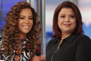 This combination of photos shows co-hosts Sunny Hostin, left, and Ana Navarro on the set of "The View," in New York on Sept. 17, 2021. Hostin and Navarro, who were abruptly pulled off the air on Friday, Sept. 24, before a planned interview with Vice President Kamala Harris said their tests were false positives. Their false positives led to some awkward television and their boss, executive producer Brian Teta, apologized to them on the air Monday. (ABC/Lou Rocco via AP)
