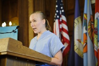 Charlotte Skinner, an Emergency Room nurse at St. Peter's Health, speaks at a Covid-19 press call hosted by Gov. Steve Bullock at the State Capitol, Tuesday, Oct. 20, 2020, in Helena, Mont. Registered nurse Skinner of Helena says healthcare workers come from a variety of political, socioeconomic and religious backgrounds, but they reach common ground on science. (Thom Bridge/Independent Record via AP)