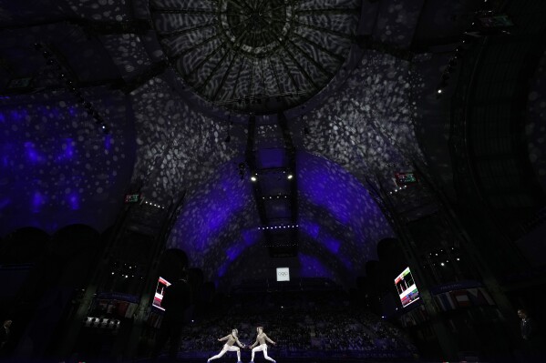 France's Manon Apithy Brunet, right, competes with France's Sara Balzer in the women's individual Sabre final match during the 2024 Summer Olympics at the Grand Palais, Monday, July 29, 2024, in Paris, France. (AP Photo/Andrew Medichini)